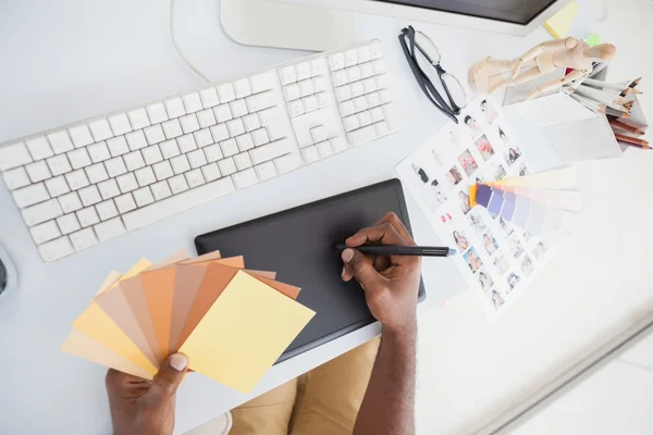 Designer using digitizer and colour wheel — Stock Photo, Image