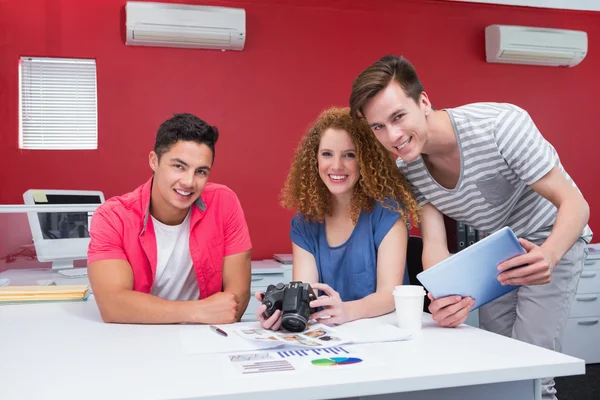 Smiling students working with camera and tablet — Stock Photo, Image