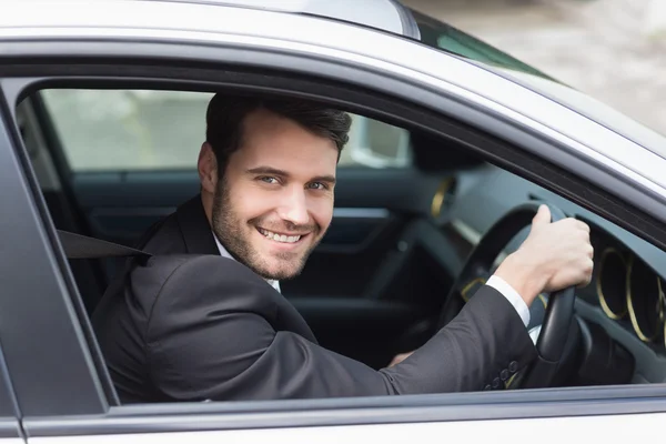 Happy businessman in the drivers seat — Stock Photo, Image