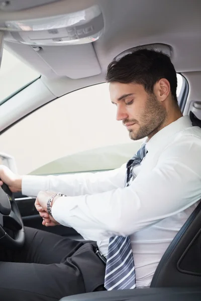 Young businessman in the drivers seat — Stock Photo, Image