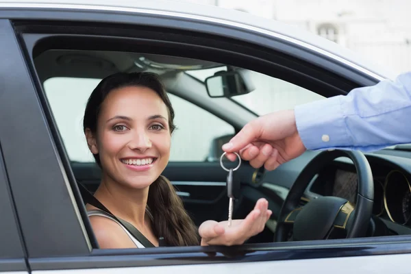 Young woman getting her key — Stock Photo, Image