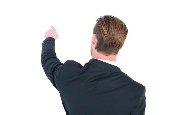 Rear view of young businessman in suit pointing — Stock Photo, Image