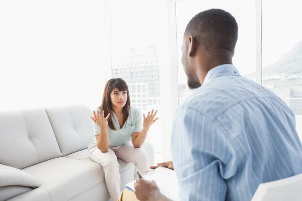 Vrouw zitten tijdens het kijken naar haar therapeut — Stockfoto