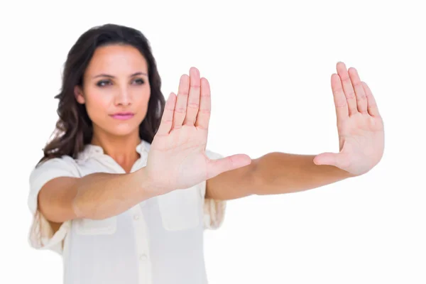 Pretty brunette holding up hands — Stock Photo, Image