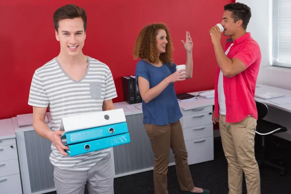 Student holding pile of ring binder — Stock Photo, Image