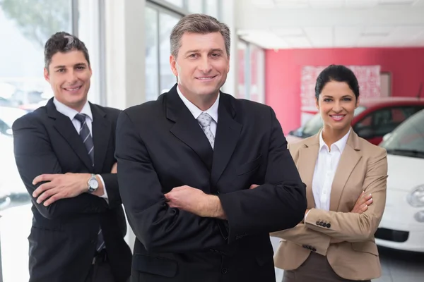 Business team standing with arms crossed — Stock Photo, Image