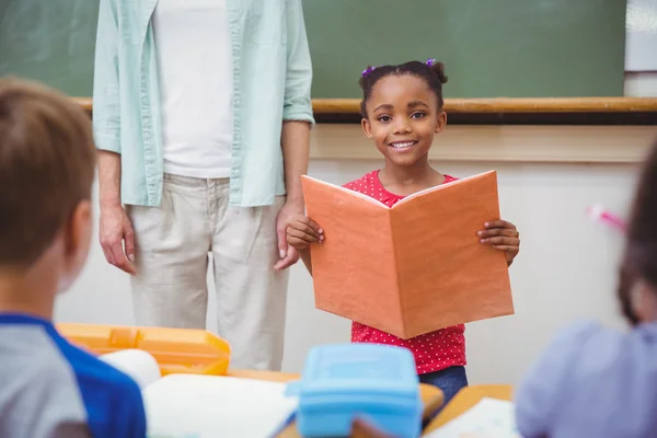 Cute pupils smiling at camera in classroom — Stock Photo, Image