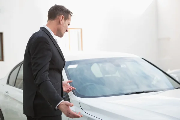 Businessman looking his car engine after breaking down — Stock Photo, Image