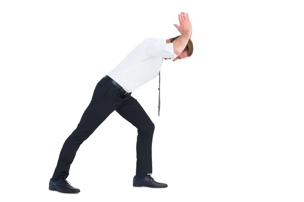 Businessman bending and pushing — Stock Photo, Image