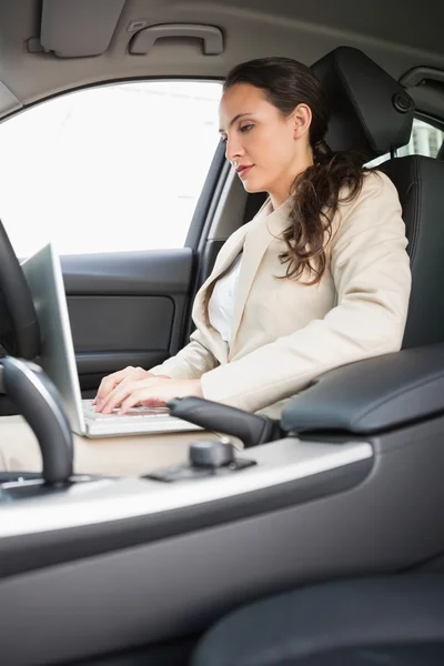 Businesswoman working in the drivers seat — Stock Photo, Image