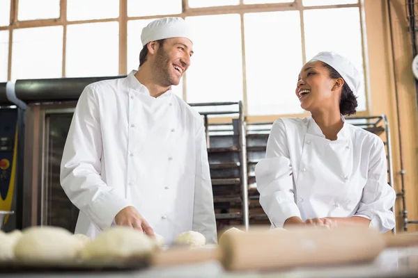 Team of bakers preparing dough — Stock Photo, Image