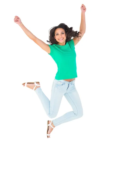 Pretty brunette jumping and smiling — Stock Photo, Image