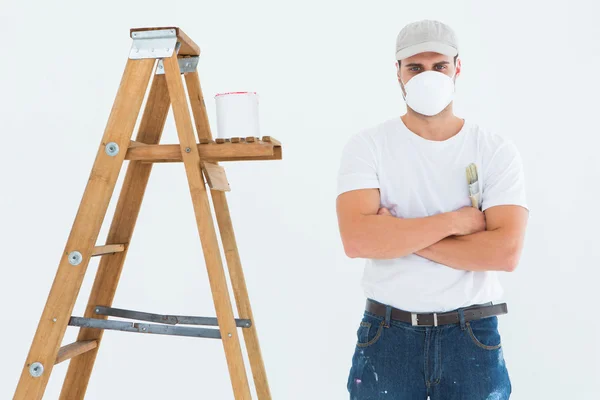 Man with paintbrush by ladder — Stock Photo, Image