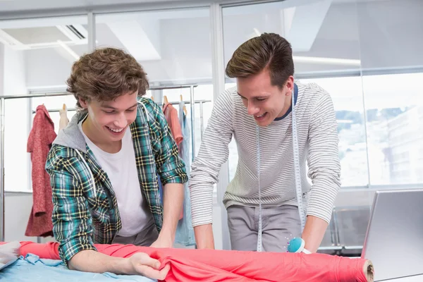 Students working together with a fabric — Stock Photo, Image