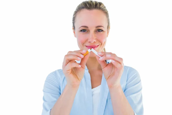 Blonde standing and breaking cigarette — Stock Photo, Image