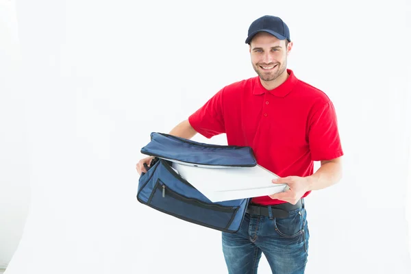 Man removing pizza box from bag — Stock Photo, Image