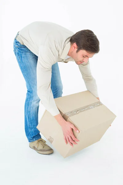 Courier man picking up cardboard box — Stock Photo, Image