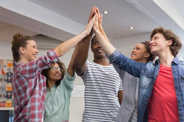 Fashion students putting hands together — Stock Photo, Image