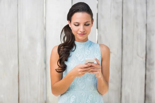 Stylish brunette using phone — Stock Photo, Image