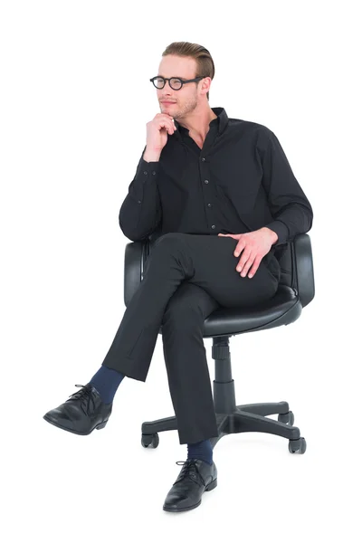 Thoughtful businessman sitting on a swivel chair — Stock Photo, Image