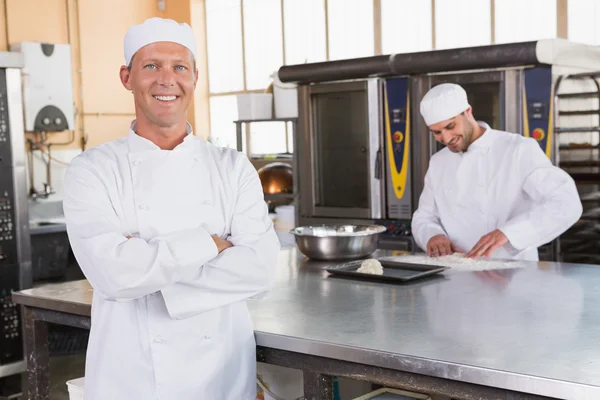 Smiling baker with arms crossed — Stock Photo, Image