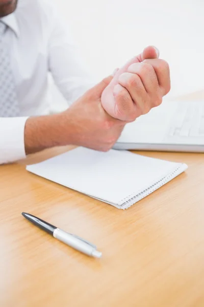 Businessman holding his hand — Stock Photo, Image