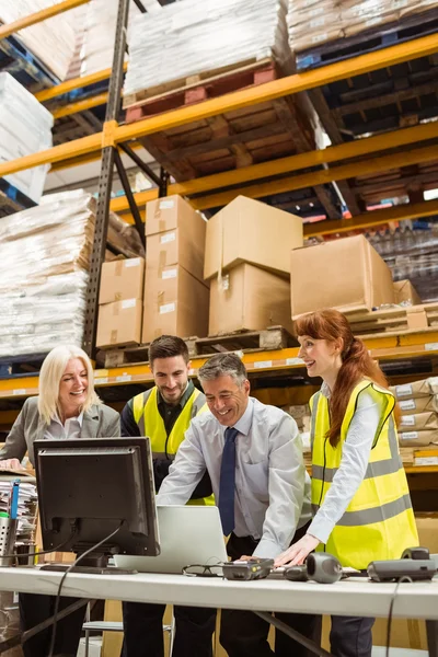 Warehouse team working together on laptop — Stock Photo, Image