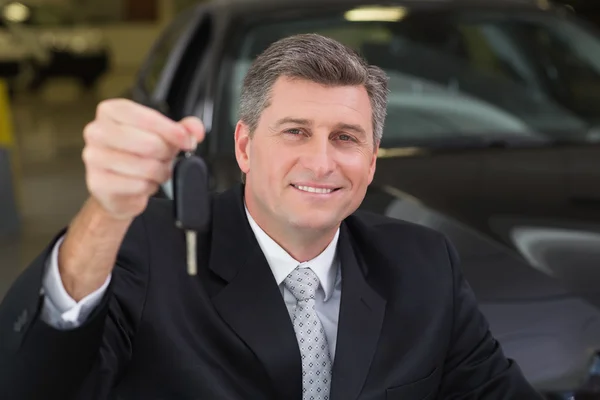 Empresário segurando chave do carro do cliente — Fotografia de Stock