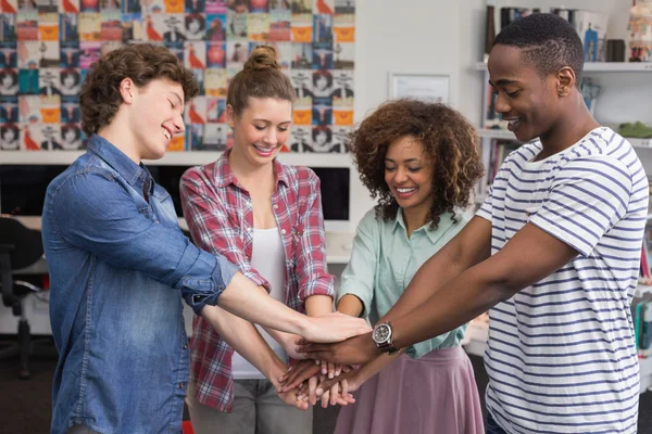 Fashion students putting hands together — Stock Photo, Image