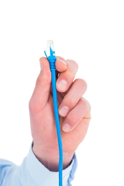 Businessman holding a cable — Stock Photo, Image