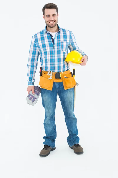 Handyman holding hard hat and gloves — Stock Photo, Image