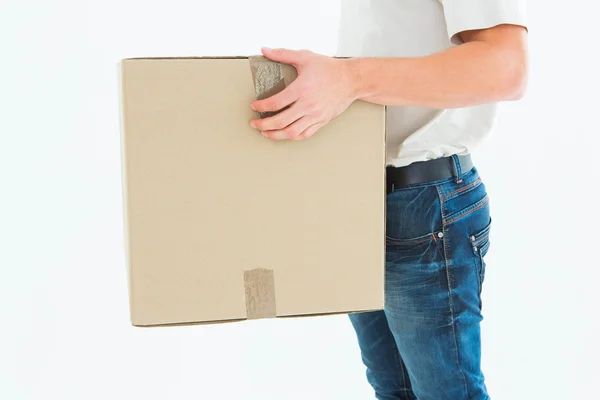 Delivery man carrying cardboard box — Stock Photo, Image