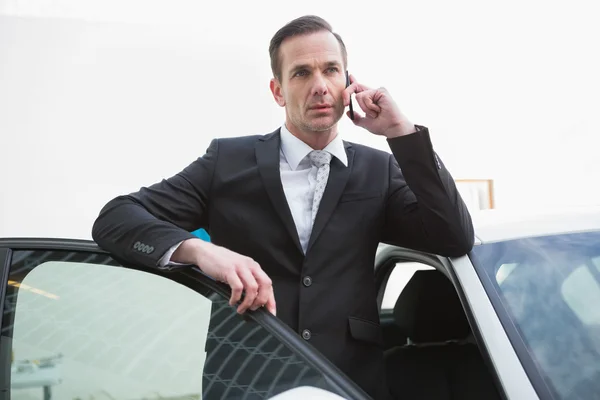 Homem de negócios sério usando seu telefone — Fotografia de Stock