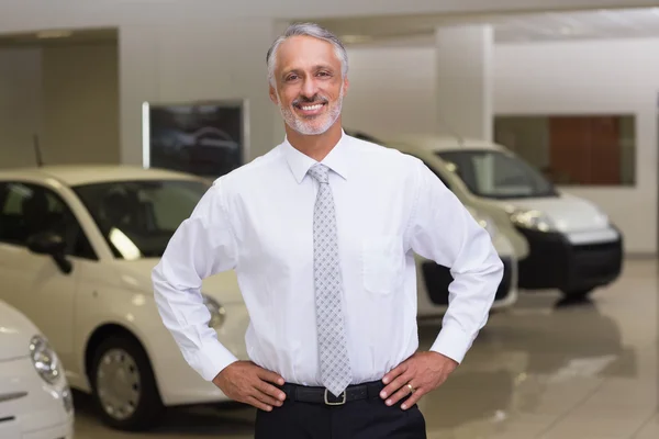 Salesman standing with hands on hips — Stock Photo, Image