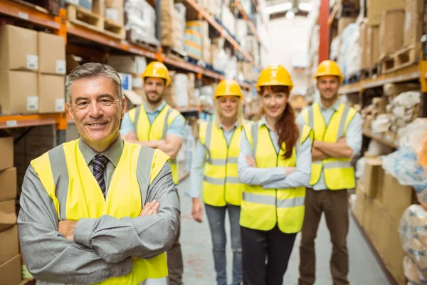 Lächelndes Lagerteam mit verschränkten Armen — Stockfoto