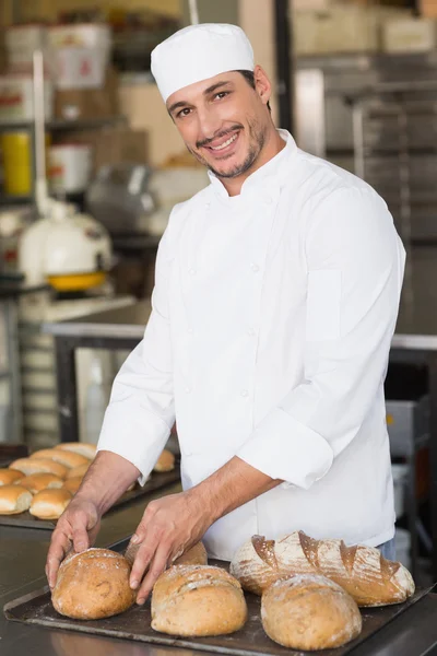 Baker checking freshly baked bread — Stock Photo, Image