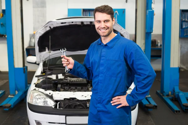 Mechanic holding pair of wrenches Royalty Free Stock Photos