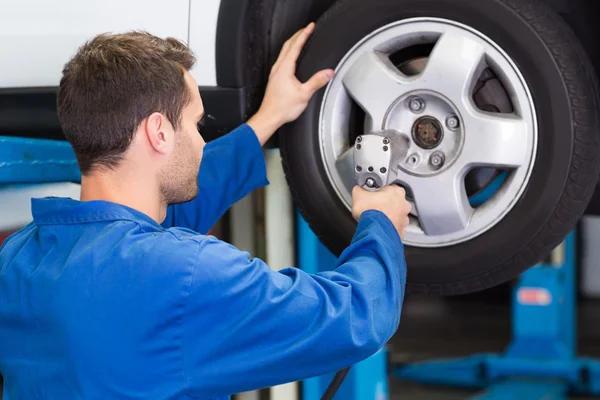 Mechanic adjusting the tire wheel Royalty Free Stock Images