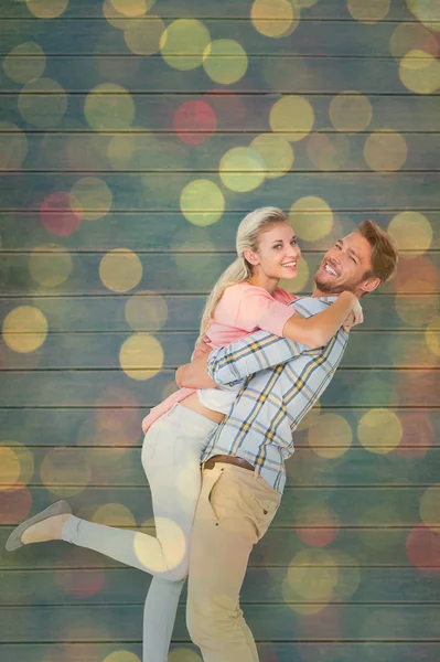Man picking up and hugging his girlfriend — Stock Photo, Image
