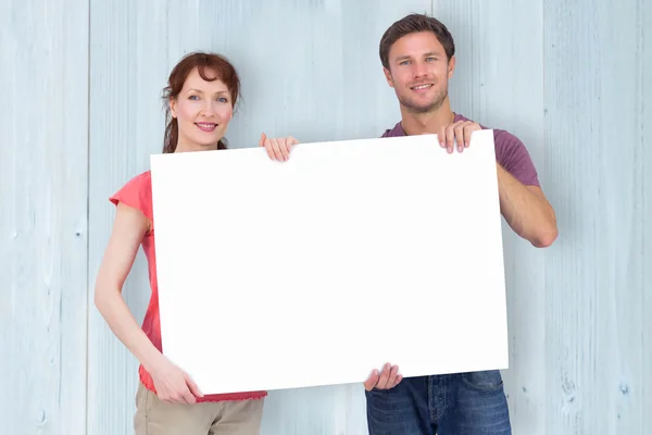 Couple holding a white sign — Stock Photo, Image