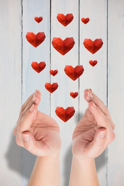 Hands presenting hearts — Stock Photo, Image