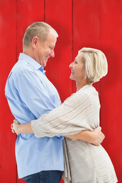 Счастливая зрелая пара обнимает и улыбается — стоковое фото
