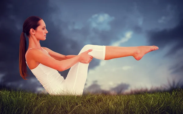 Toned woman doing the boat pose — Stock Photo, Image