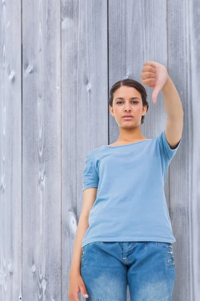 Pretty brunette giving thumbs down — Stock Photo, Image