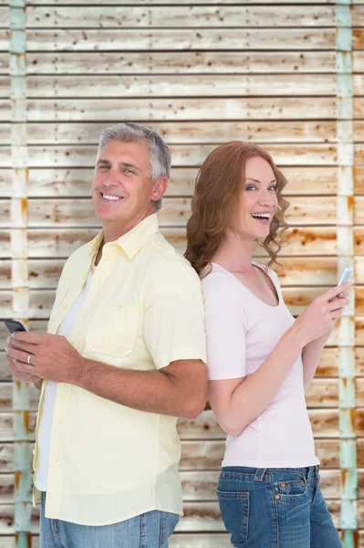 Casual couple sending text messages — Stock Photo, Image