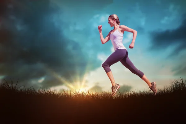 Blonde jogging over grass — Stock Photo, Image