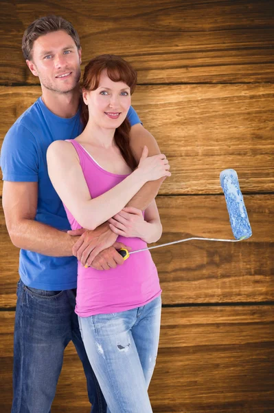 Couple hugging and holding brush — Stock Photo, Image