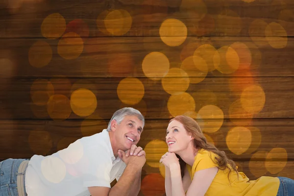 Casual couple lying on floor — Stock Photo, Image