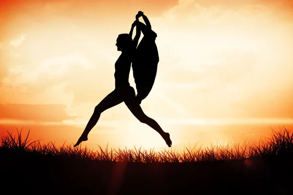 Gorgeous fit woman leaping with scarf — Stock Photo, Image