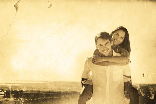 Man giving girlfriend a piggy back — Stock Photo, Image